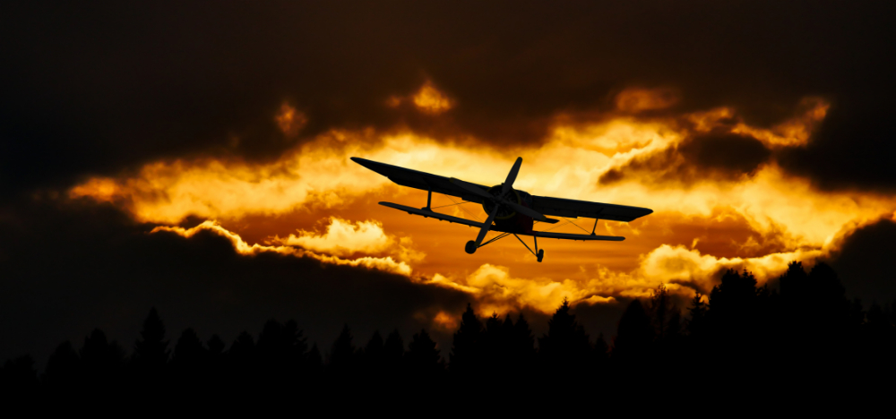 Airplane flying into the sunset